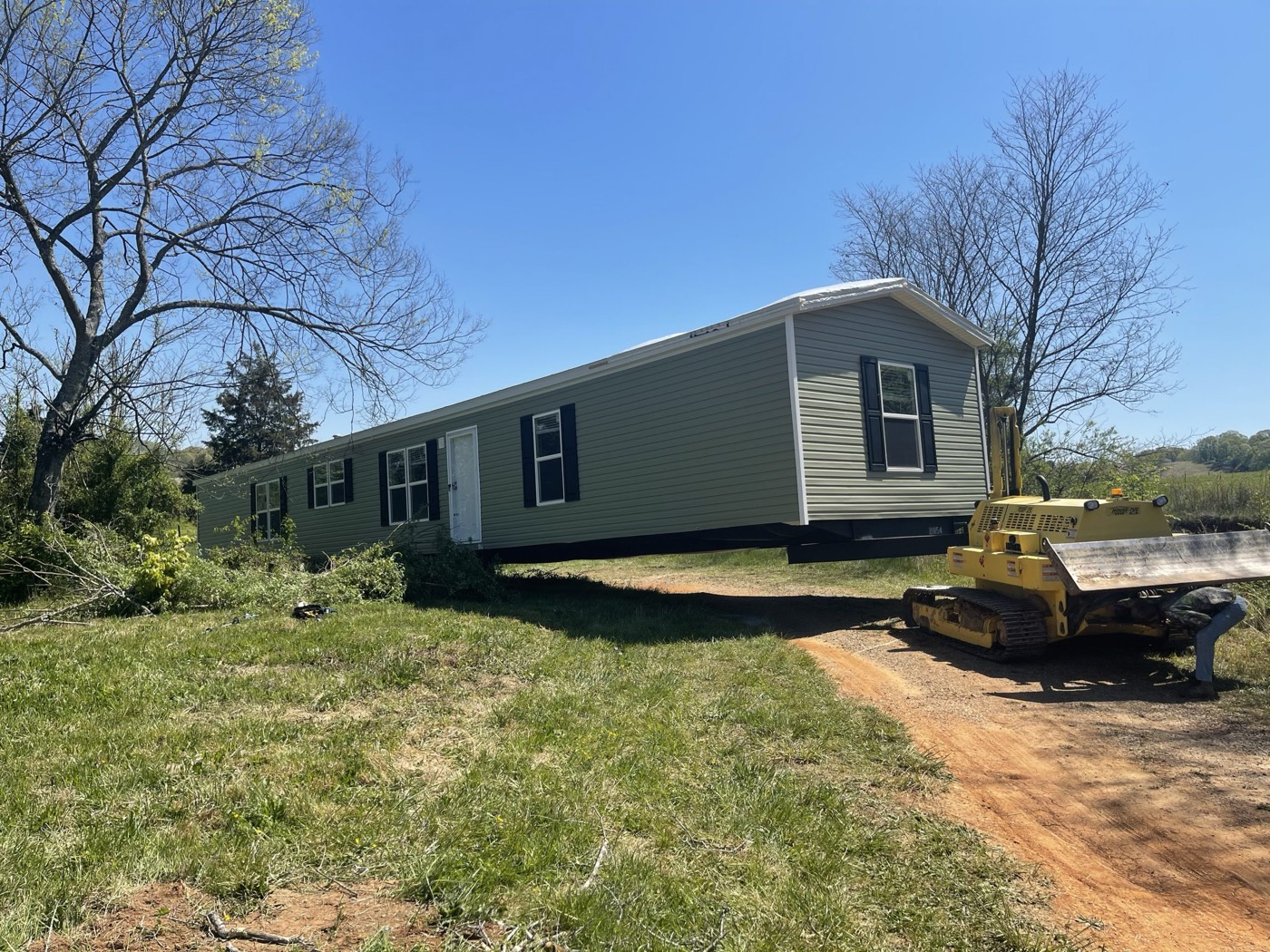 Skidsteer assisting with a home set